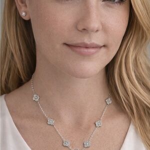 White gold over stainless steel clover, pave set stones.